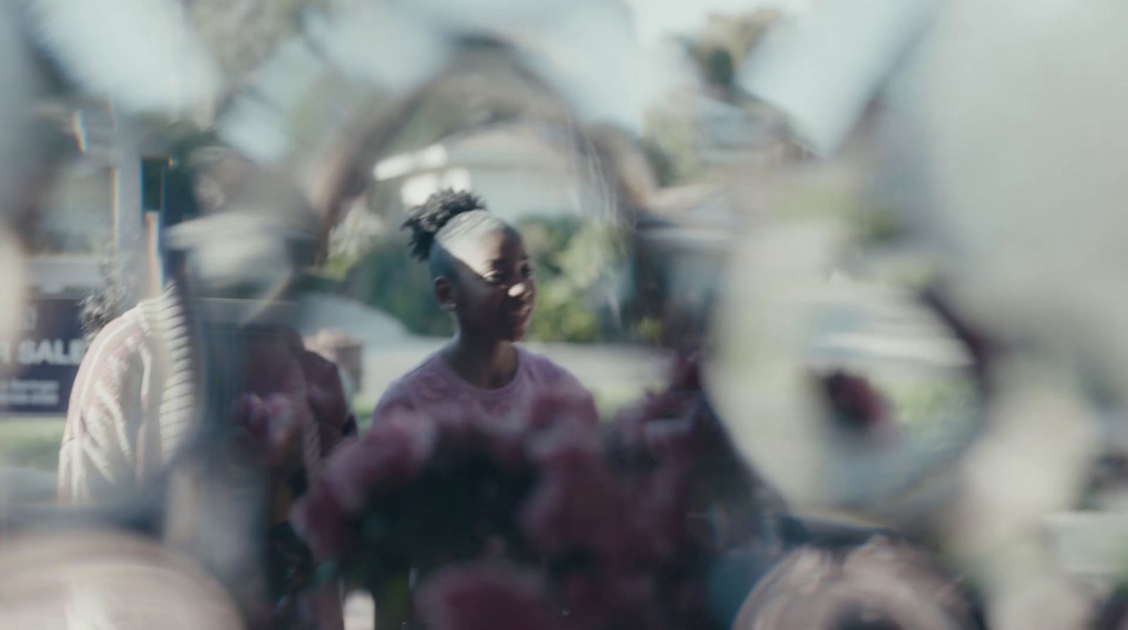 a woman is seen through a glass window