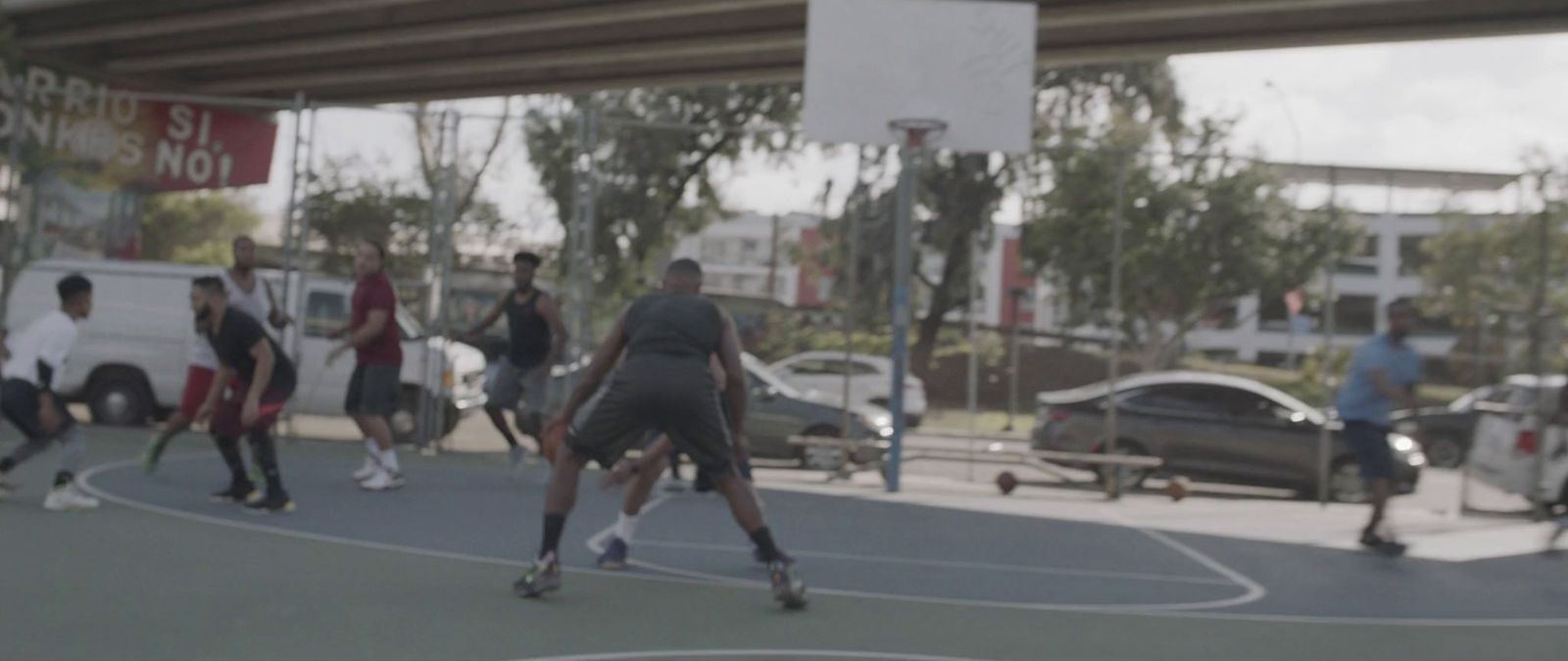 a group of young men playing a game of basketball