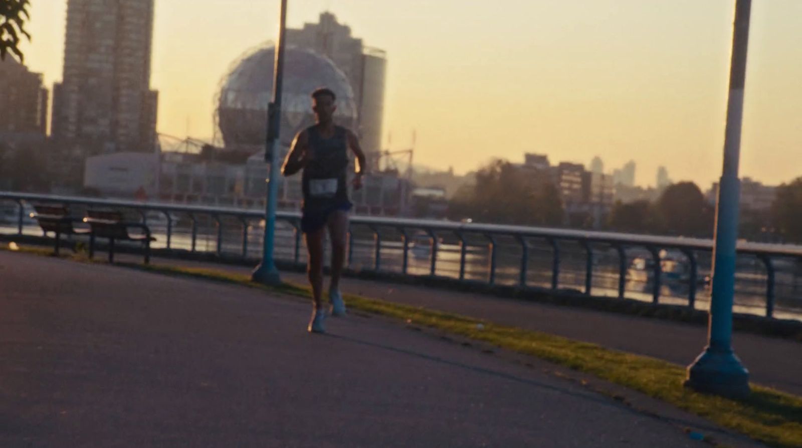 a man running down a street next to a bridge