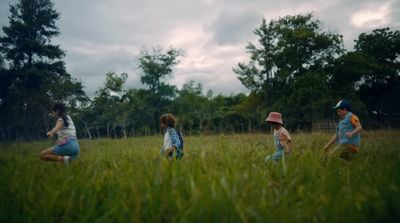 a group of children running through a field