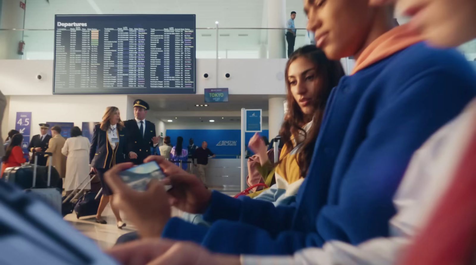 a group of people standing next to each other at an airport