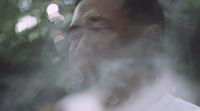 a close up of a person smoking a cigarette