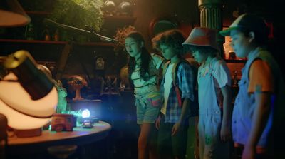 a group of young children standing around a table