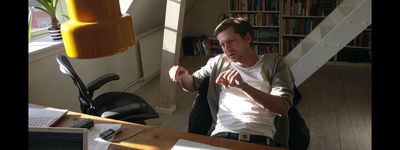 a man sitting in a chair in front of a desk