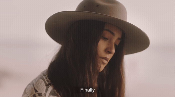 a woman with long hair wearing a hat