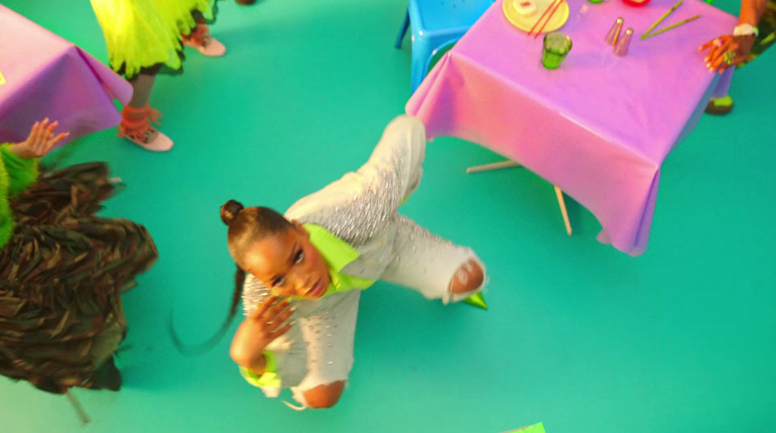 a small child is standing in front of a table