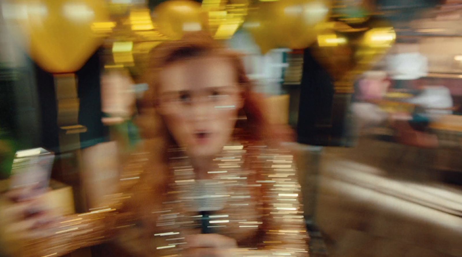 a blurry photo of a woman holding a cell phone