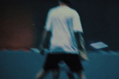 a blurry image of a man holding a tennis racket