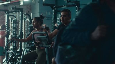 a group of people riding stationary exercise bikes in a gym