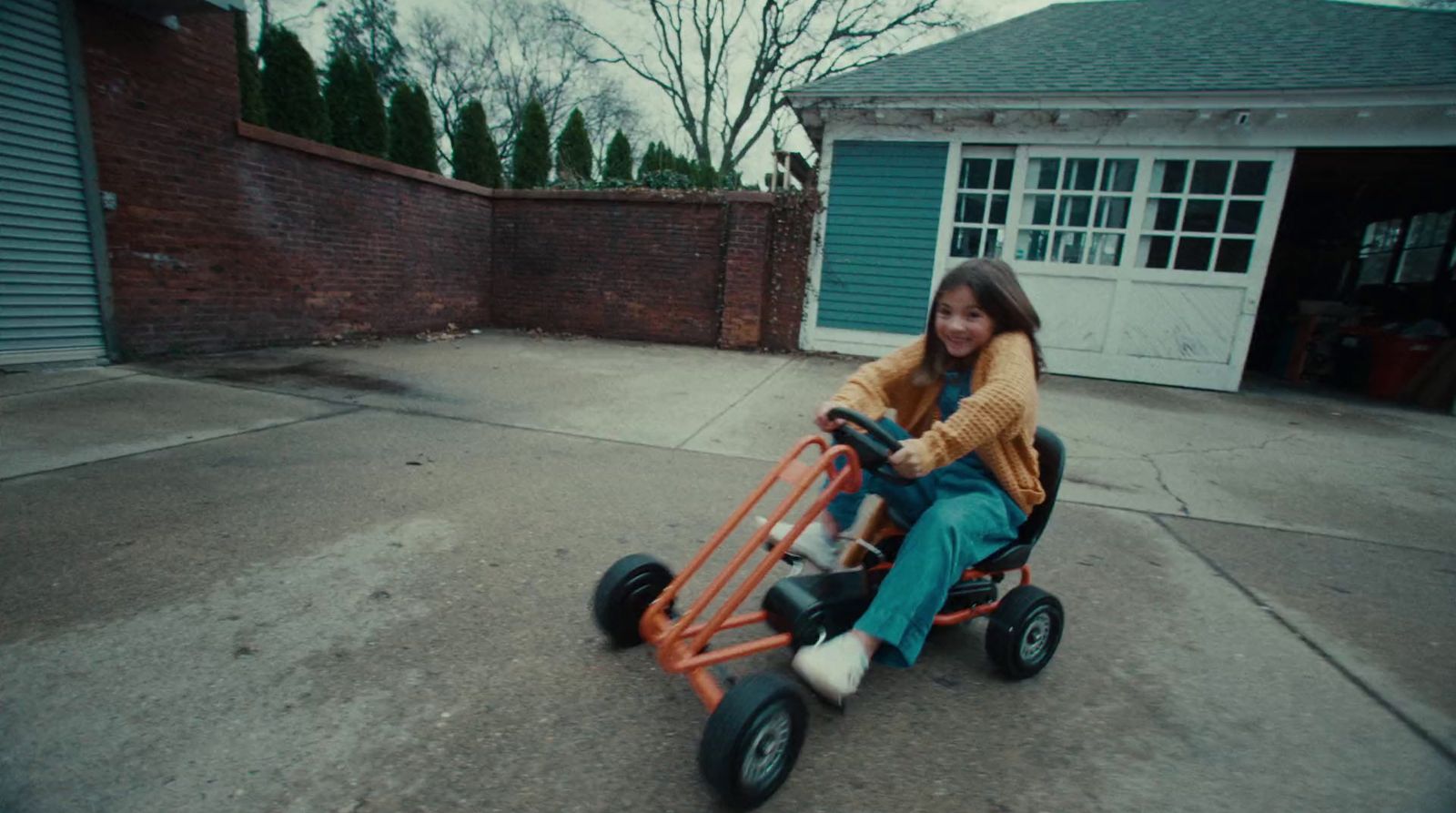 a girl is sitting on a small cart