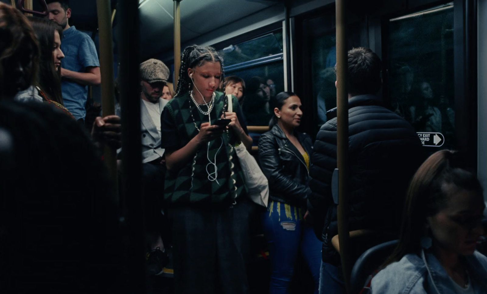 a group of people standing on a train next to each other