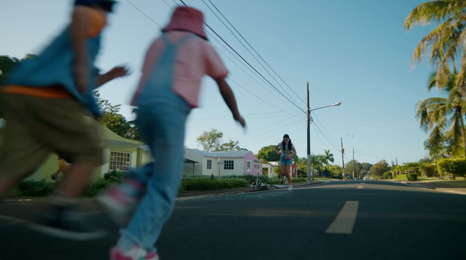 a couple of people riding skateboards down a street