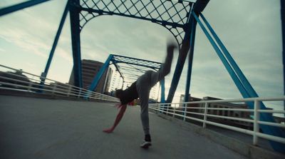 a person riding a skateboard on a bridge