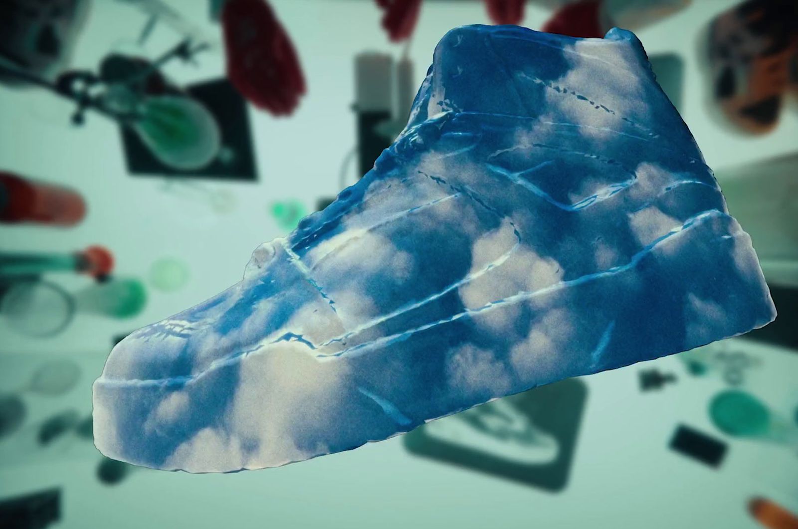 a picture of a blue shoe with clouds on it