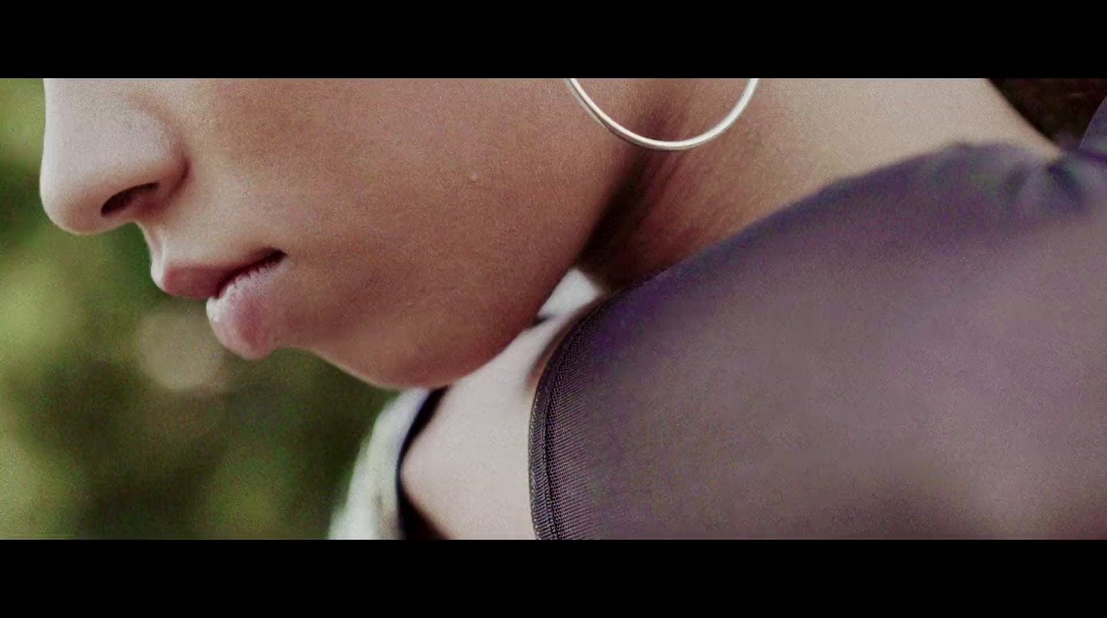 a close up of a person wearing a pair of hoop earrings