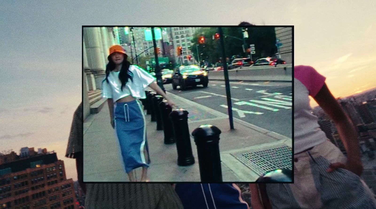 a woman walking down a street next to a tall building