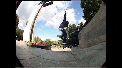 a man riding a skateboard up the side of a cement wall