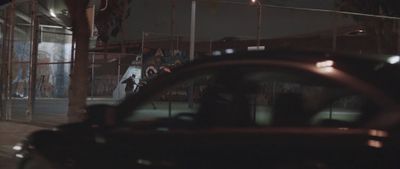 a car parked on the side of a road at night