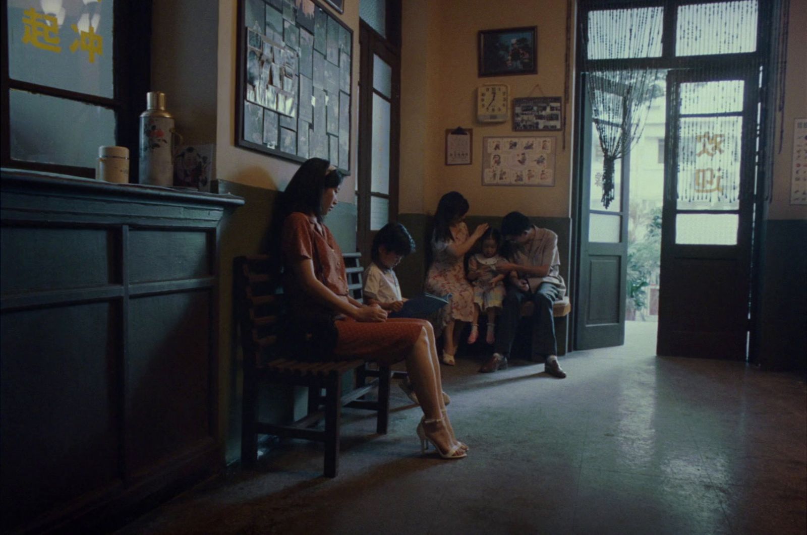 a woman sitting on a bench in front of a group of children