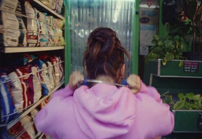 a woman in a pink dress standing in a store