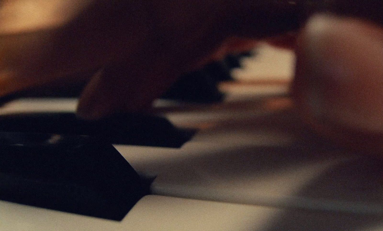 a close up of a person playing a piano