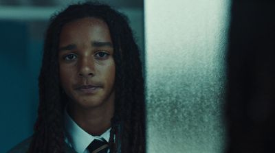 a man with long hair wearing a tie