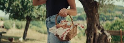 a person holding a basket with eggs in it