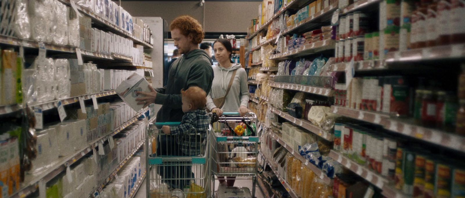 a man and a woman shopping in a grocery store