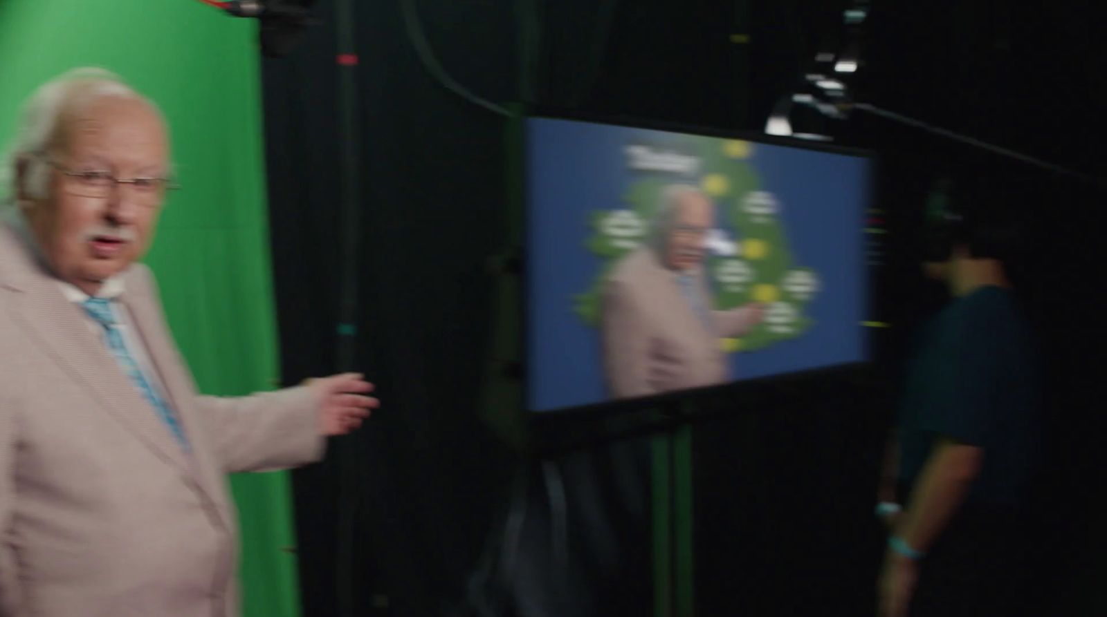 a man standing in front of a green screen