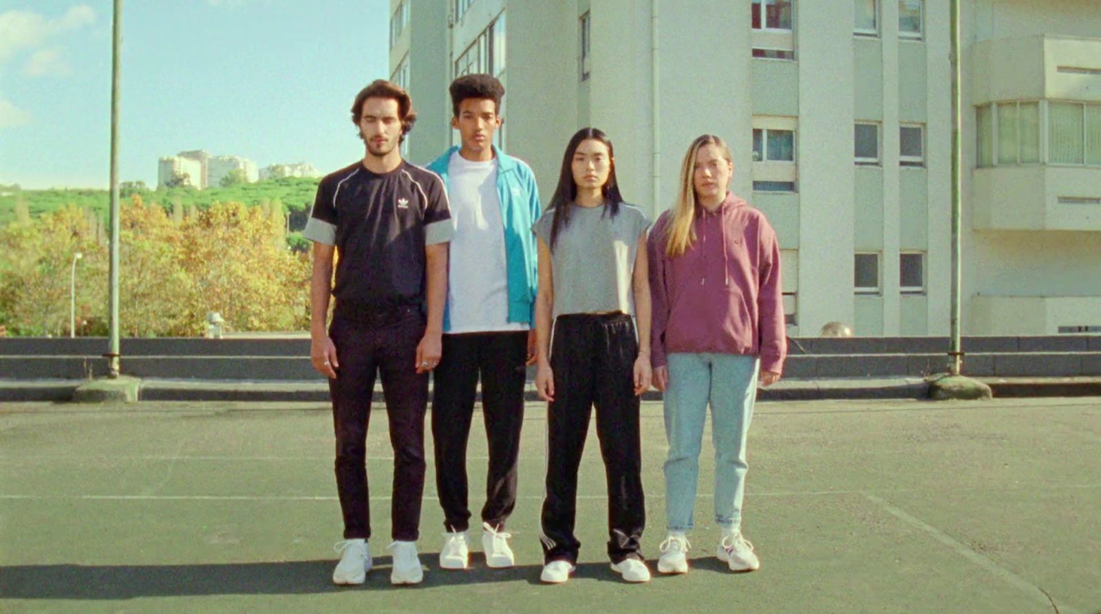 a group of people standing on top of a tennis court