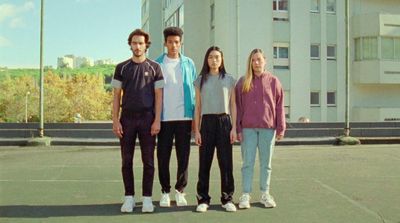 a group of people standing on top of a tennis court