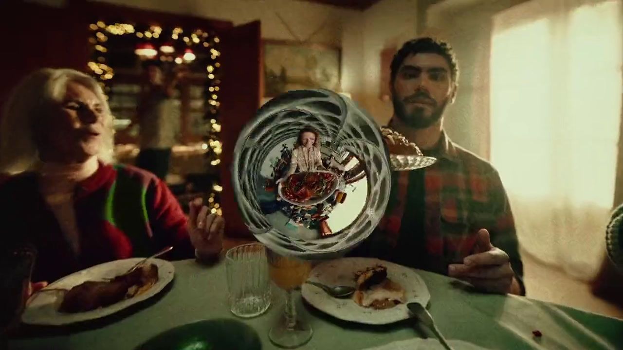 a man and woman sitting at a table with plates of food