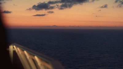 a view of the ocean at sunset from a ship