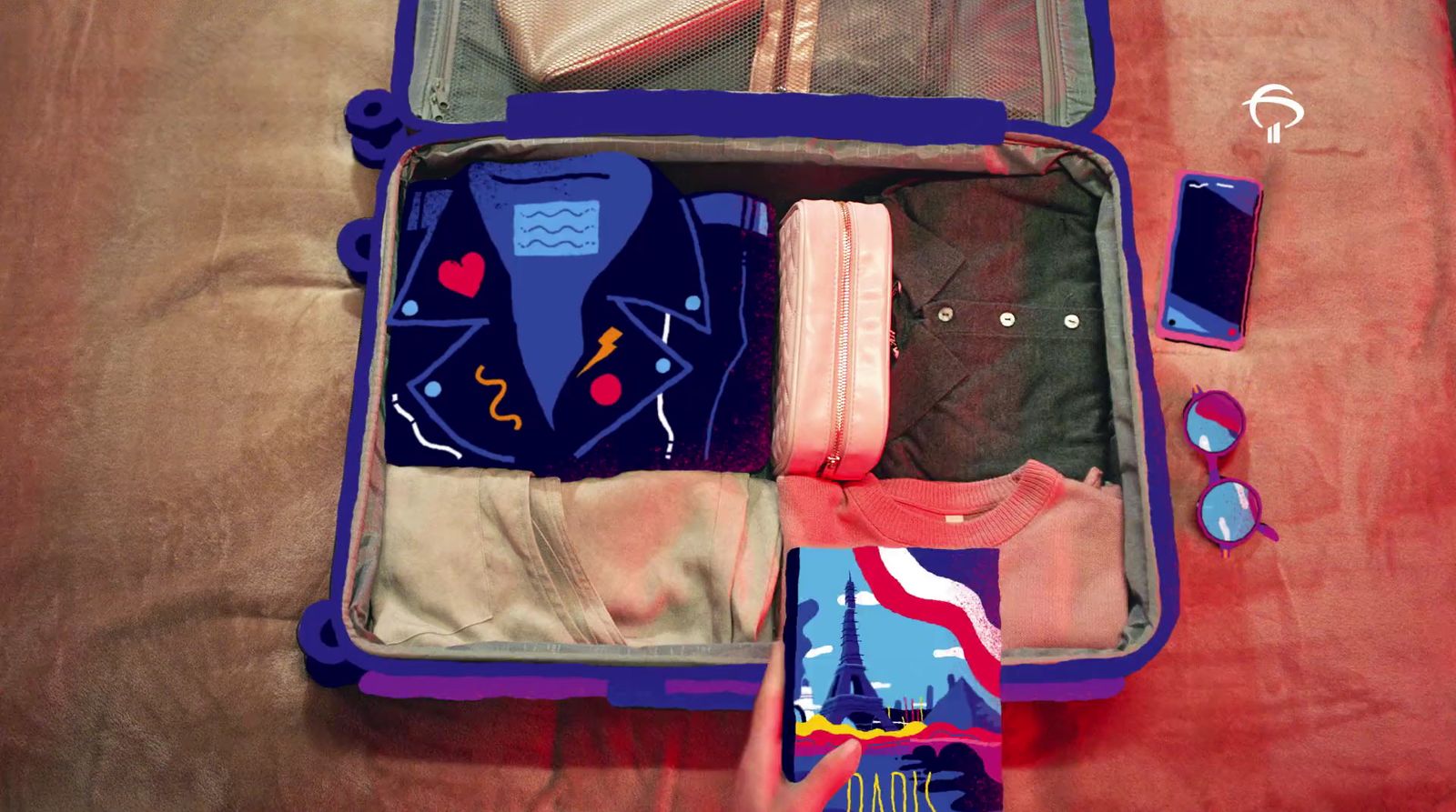 an open suitcase filled with clothes on a bed