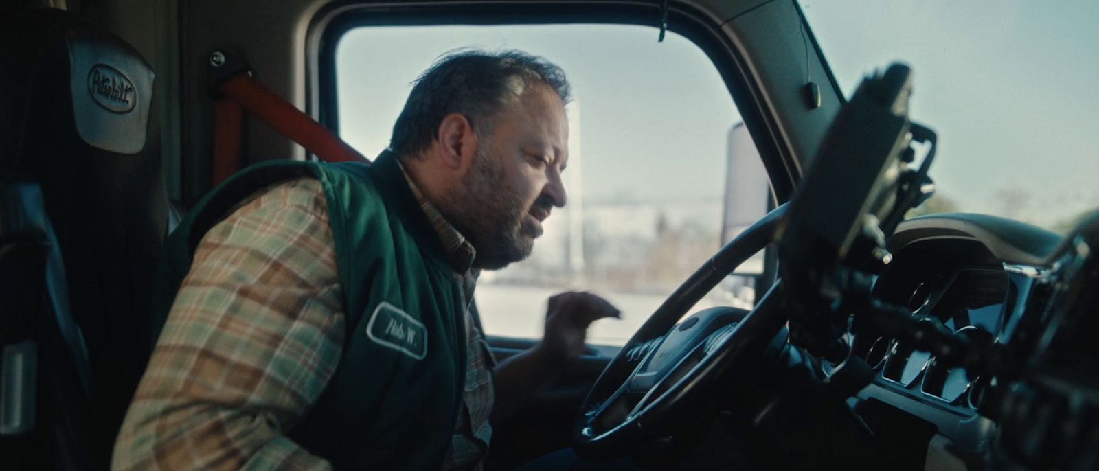 a man sitting in the driver's seat of a truck