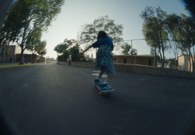 a person riding a skateboard down a street