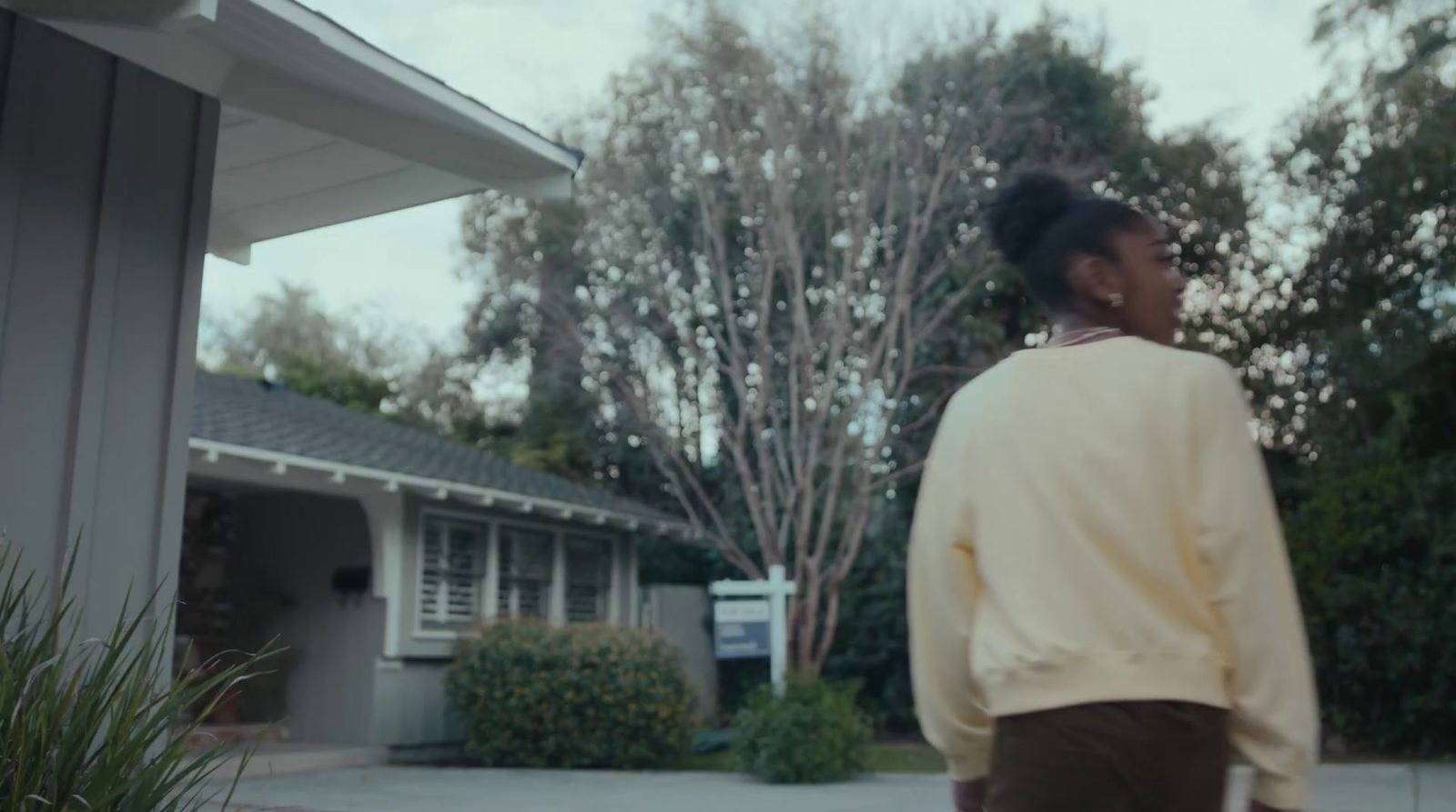 a woman standing in front of a house