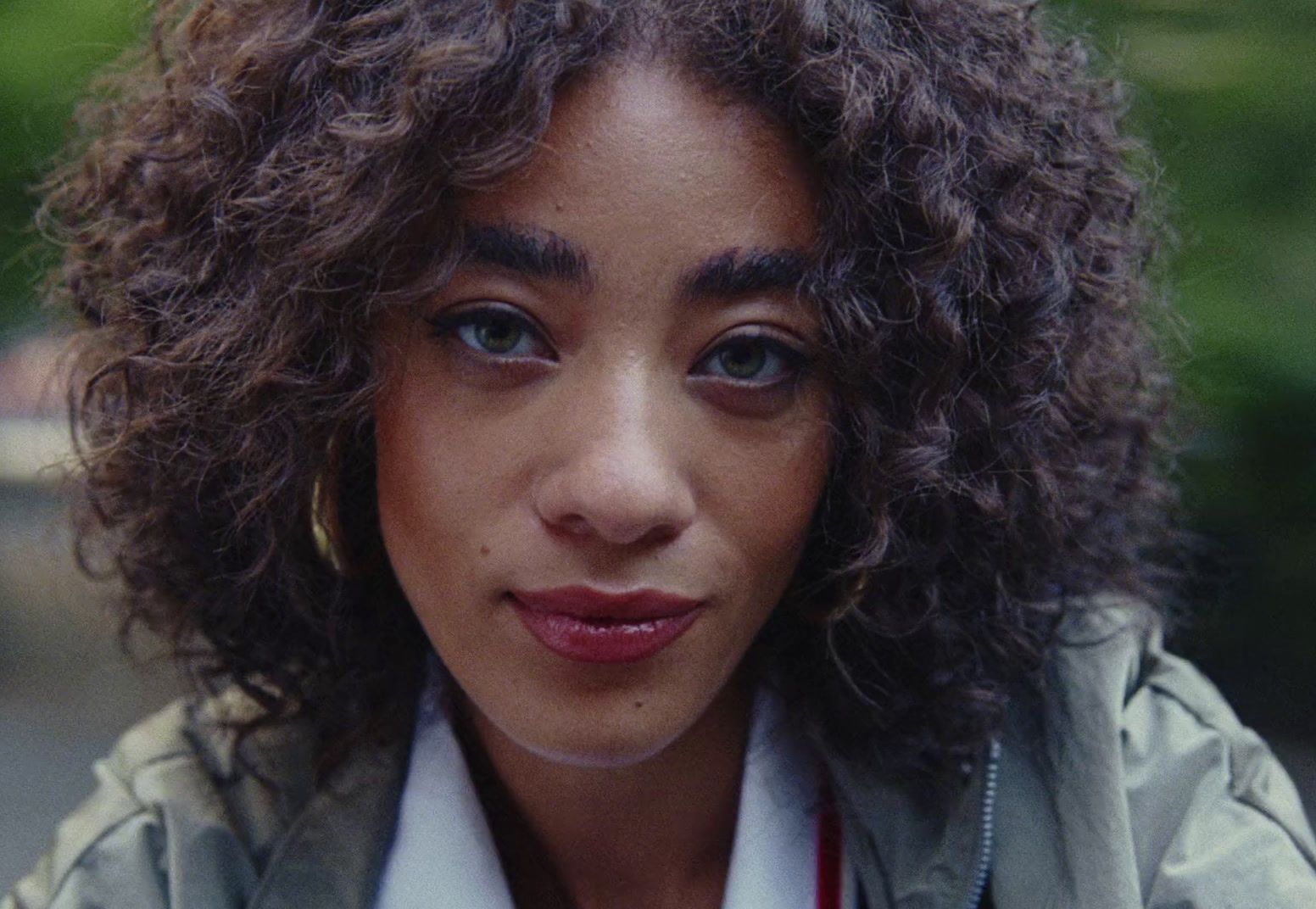 a close up of a person with curly hair