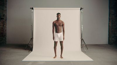 a man standing in front of a white backdrop