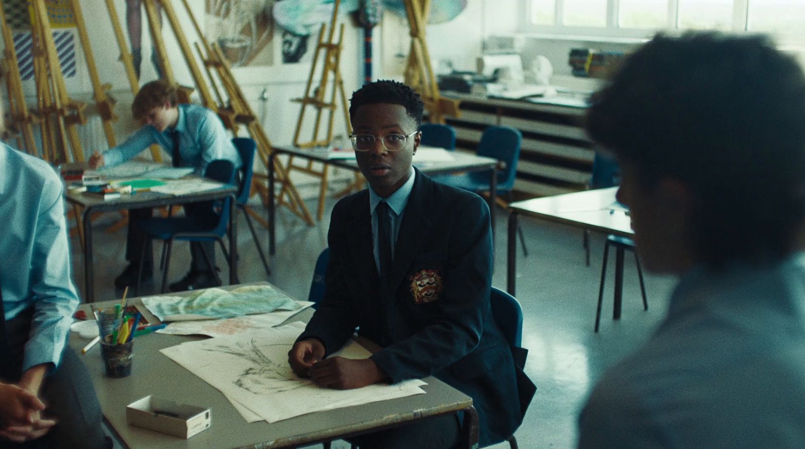 a man sitting at a desk in a classroom