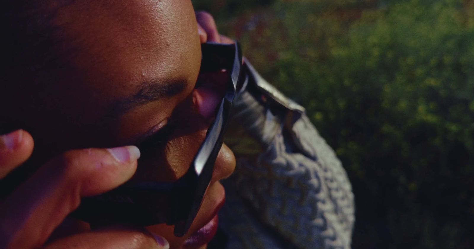 a close up of a person talking on a cell phone