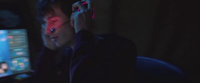 a man sitting in front of a computer in the dark