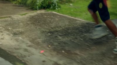 a man riding a skateboard down a cement ramp