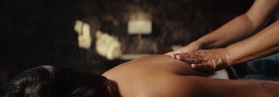 a woman getting a back massage at a spa