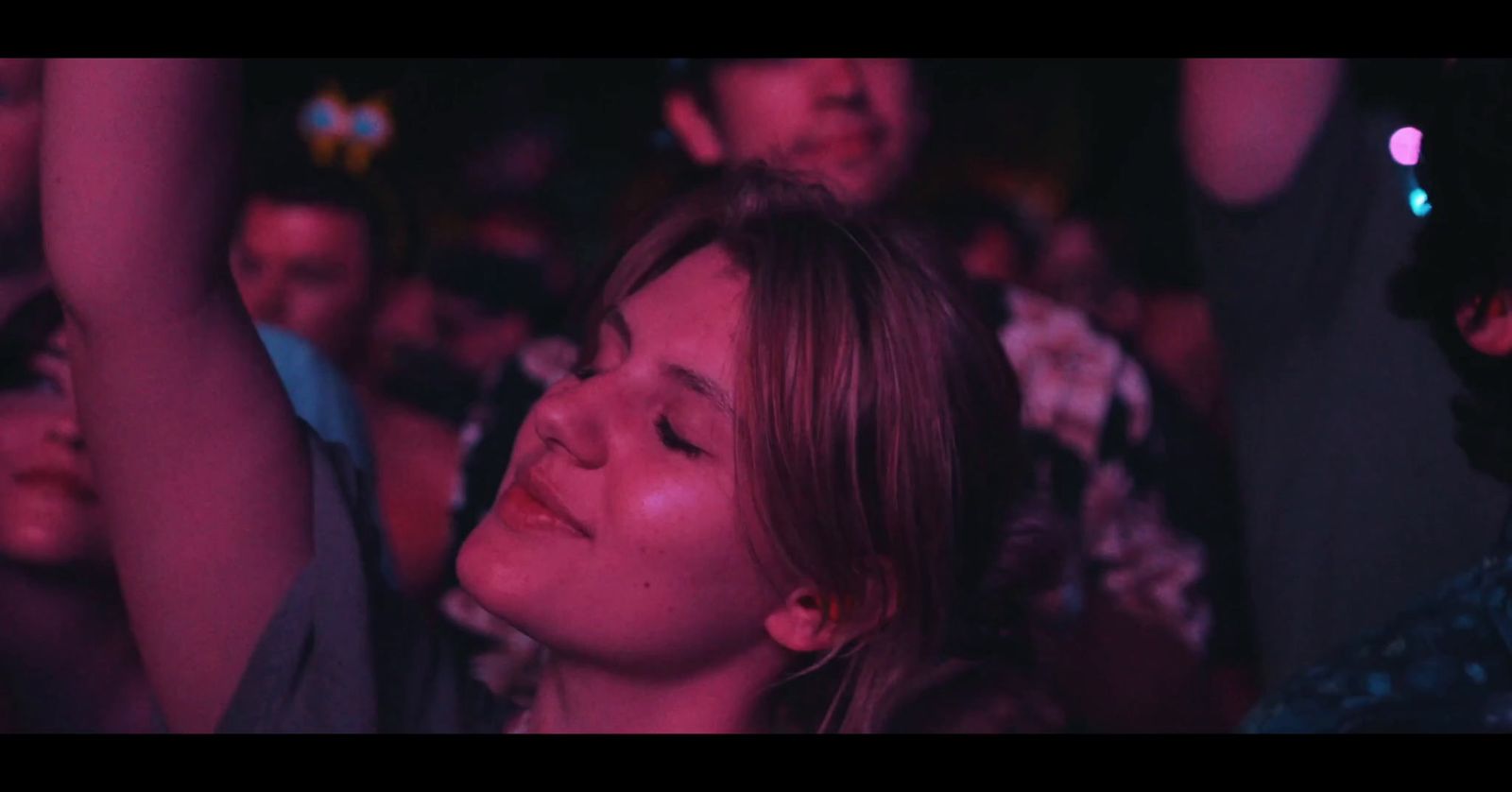 a woman in a crowd of people at a concert