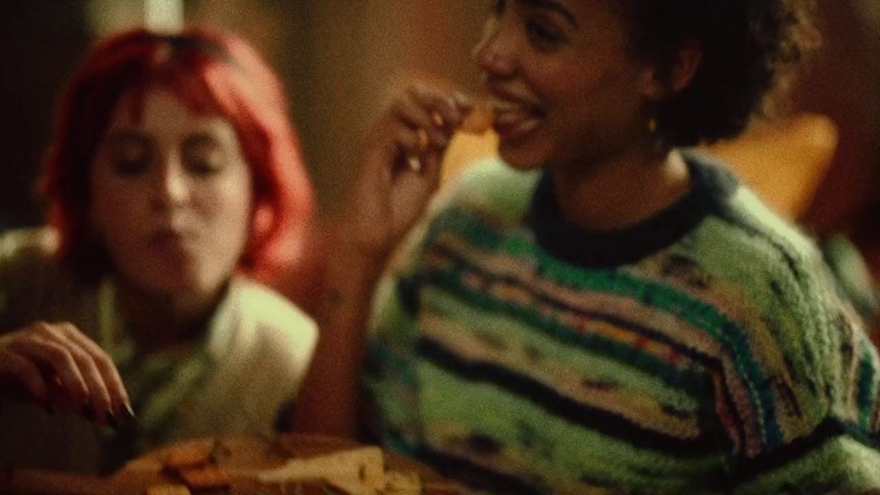 two women sitting at a table eating food