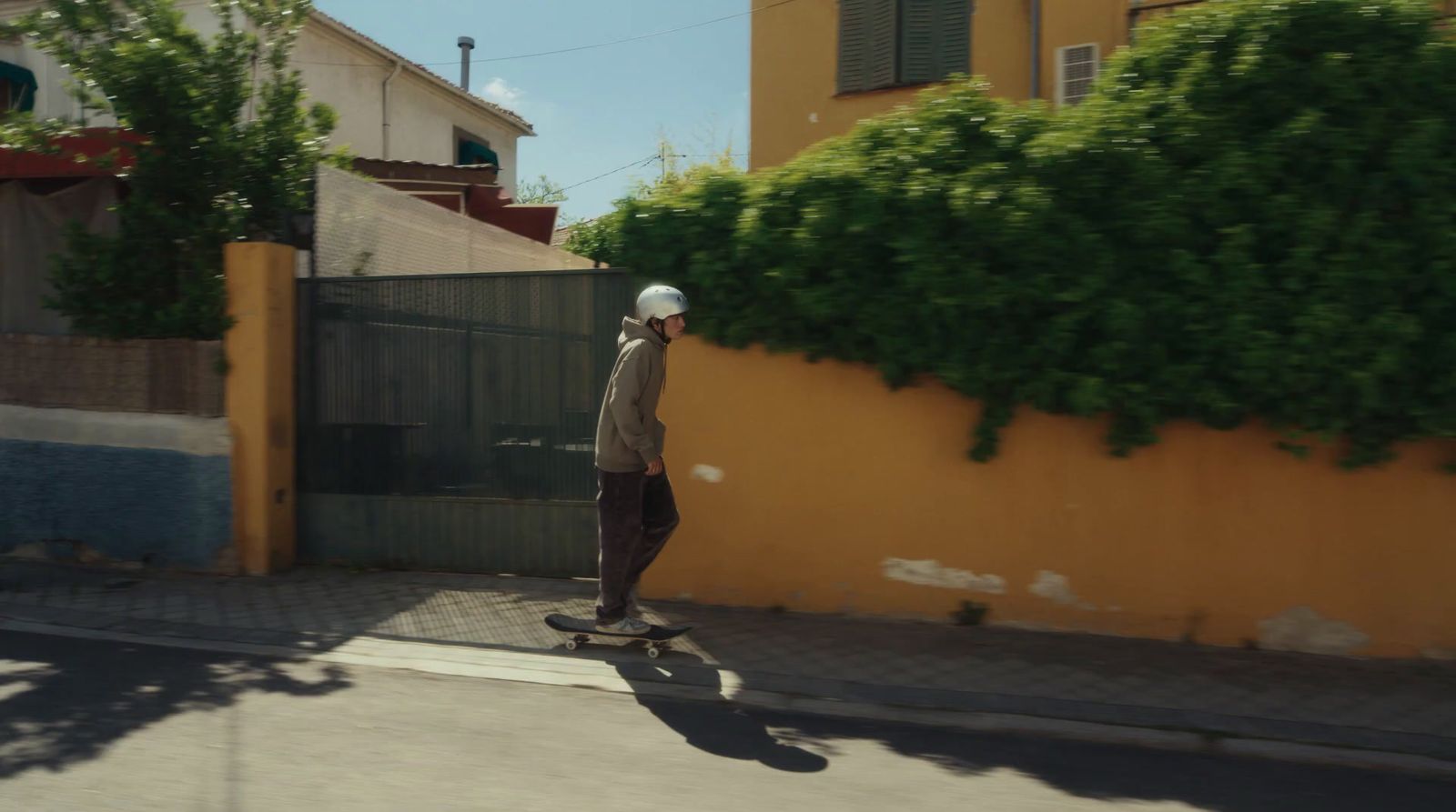 a man riding a skateboard down a street