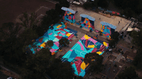 an aerial view of a playground with a colorful mural