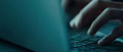 a close up of a person typing on a laptop