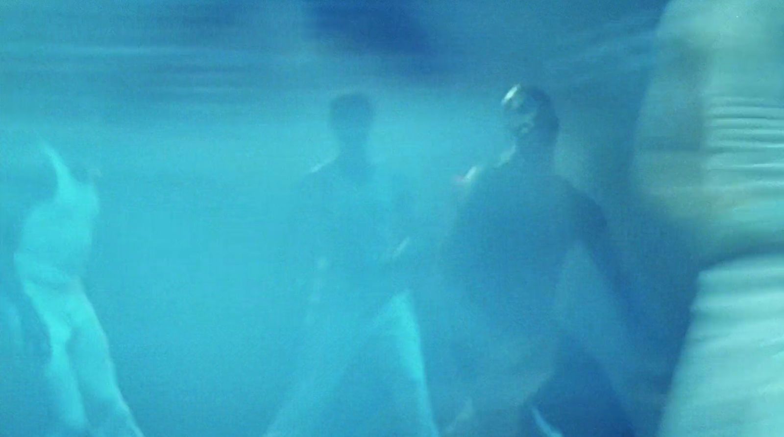 a blurry photo of a man and a woman under water